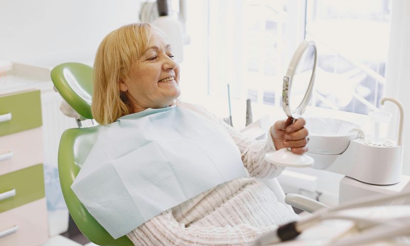 Smiling patient after dental implant treatment in Houston