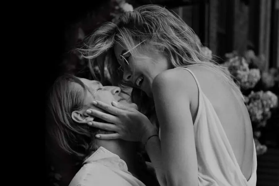 Smiling couple sharing an intimate moment outdoors, symbolizing the warmth and connection of home life in Shawnee Park.