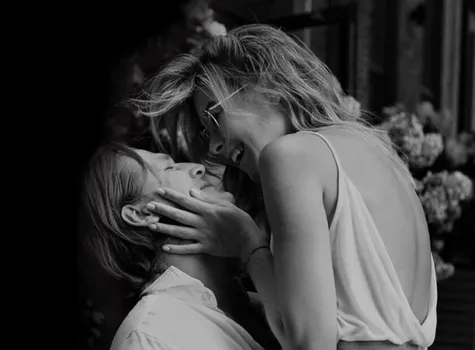 Smiling couple sharing an intimate moment outdoors, symbolizing the warmth and connection of home life in Shawnee Park.