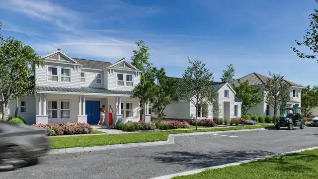 Street level view of new single family homes in the SeaFlower community in Parrish, Florida, featuring coastal style architecture, front porches, and landscaped streets.