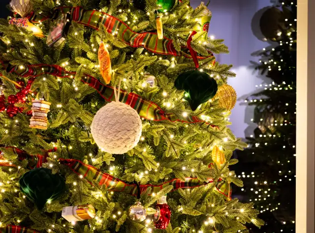 Close up of a decorated Christmas tree at Alpine Park TreeFest, featuring food themed ornaments and holiday lights