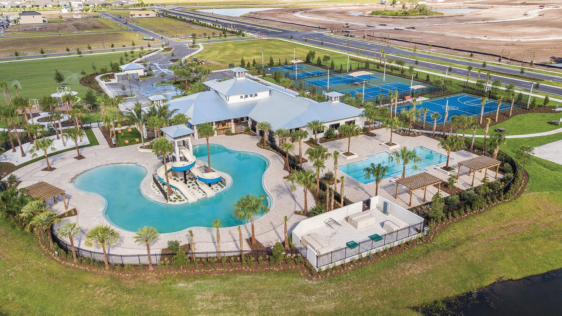 Aerial view of Waterset amenities in Apollo Beach, including pools, a clubhouse and sports courts.