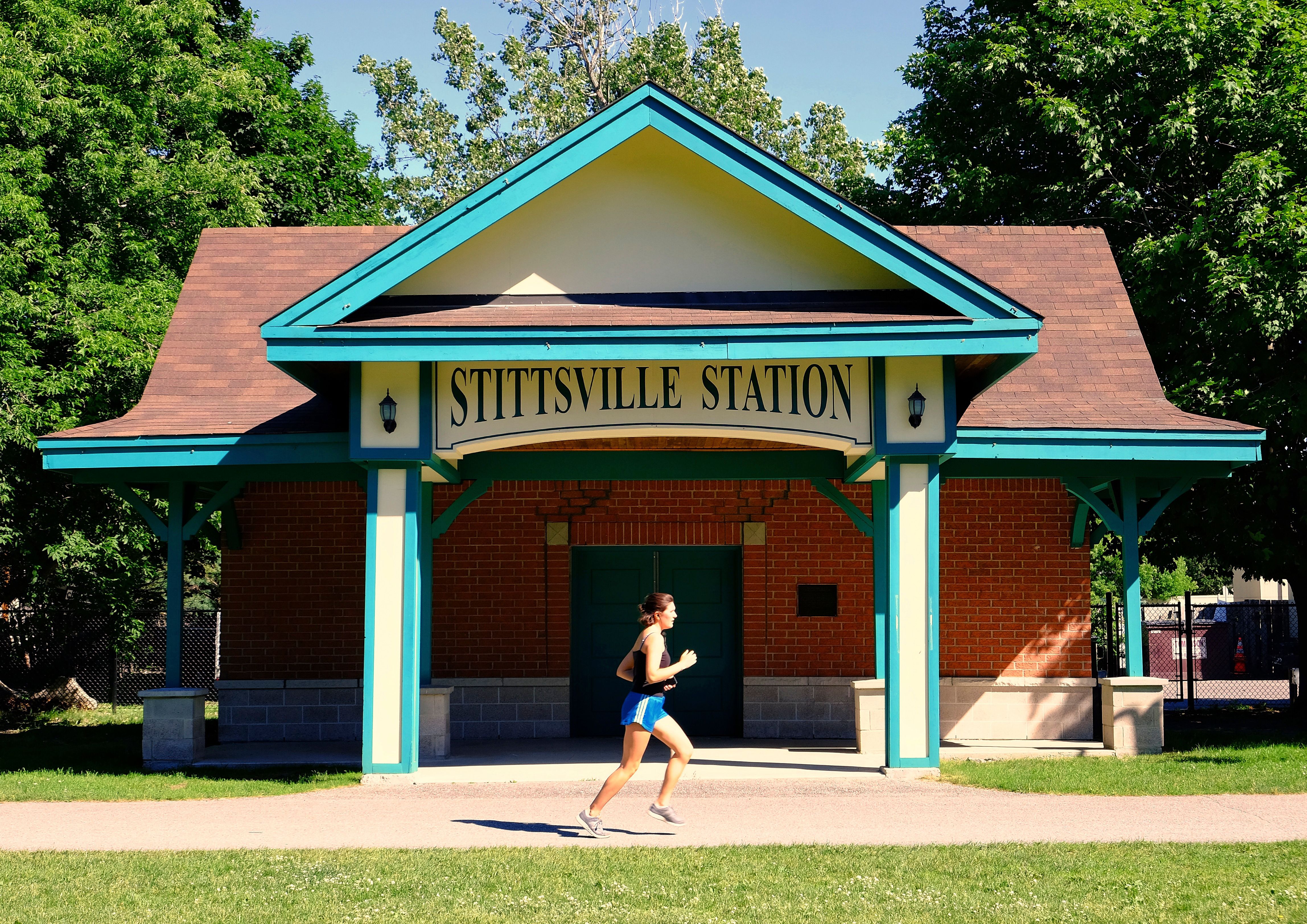 A person jogging past Stittsville Station beside the Trans Canada Trail in Stittsville, Ottawa.