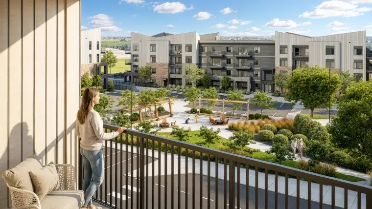 View from a Metro One condo balcony overlooking landscaped green space and condominium buildings in Silverton, Calgary.
