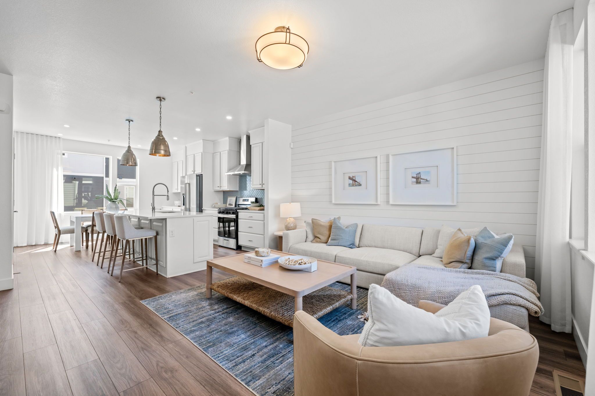 Open-concept living room and kitchen inside a modern Westminster Station townhome near Denver Colorado