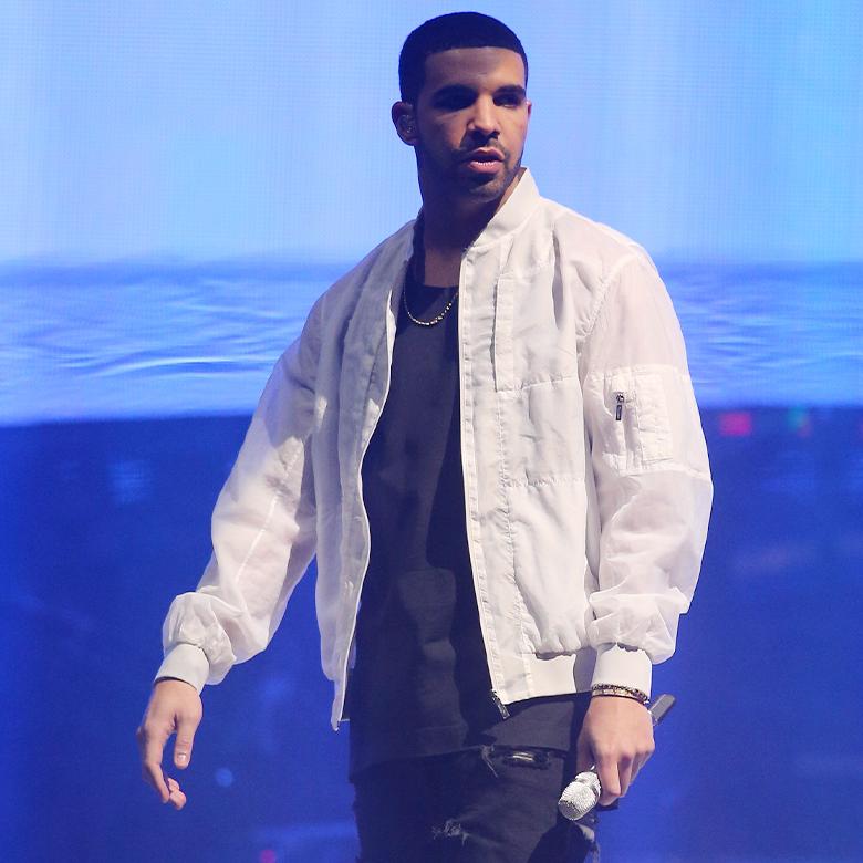 Drake on stage against a blue backdrop