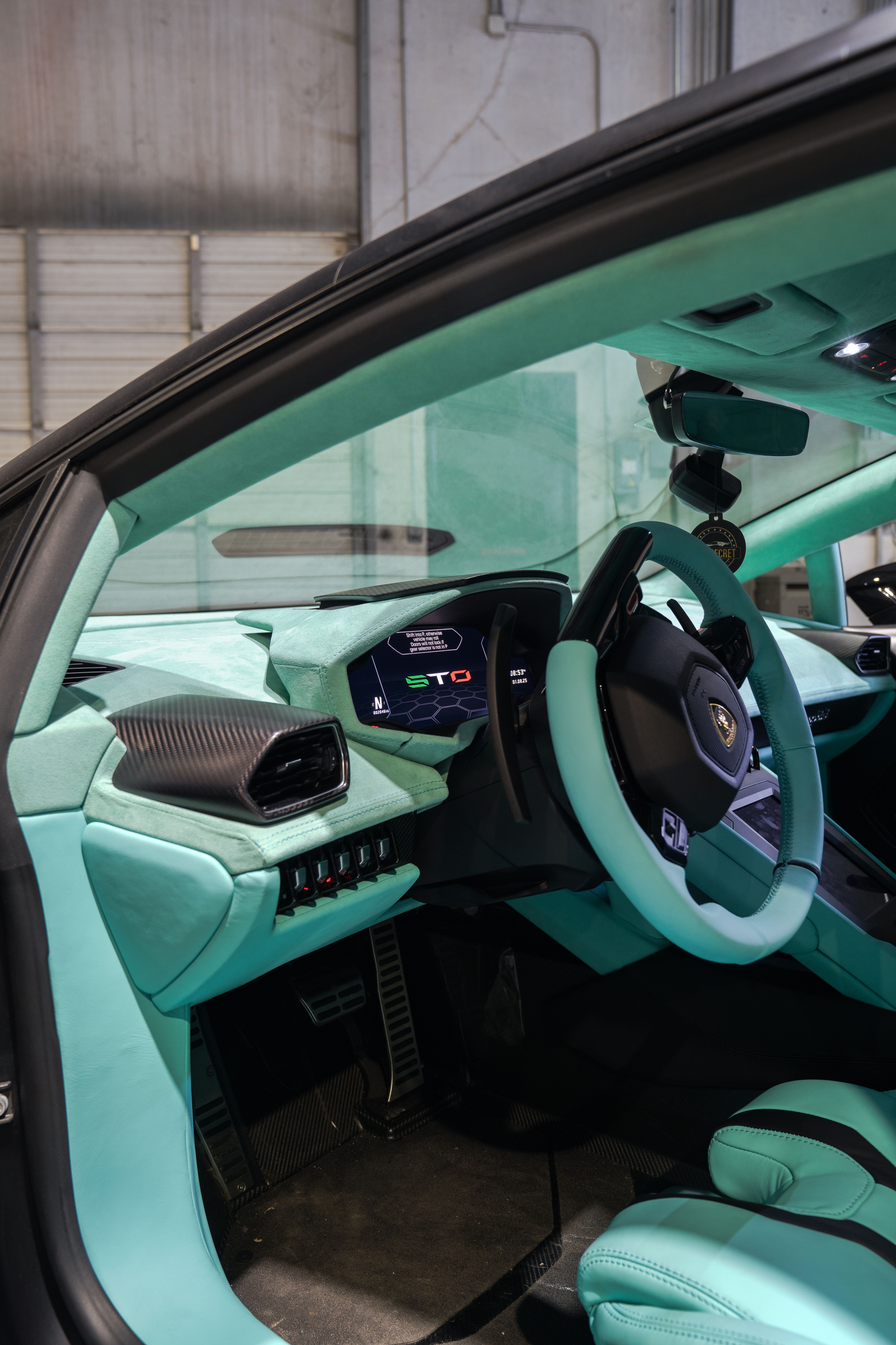 Custom center console leather wrapping and interior trim fabrication in Houston. Bespoke armrests, shifter surrounds, and accent panel retrimming for custom car builds.