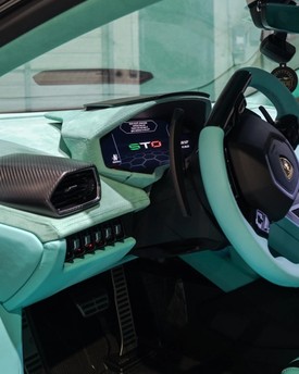 Custom center console leather wrapping and interior trim fabrication in Houston. Bespoke armrests, shifter surrounds, and accent panel retrimming for custom car builds.
