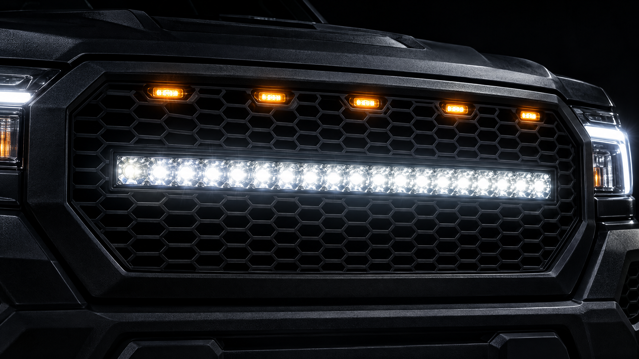 Flush-mounted LED light bars and amber grill markers on a custom off-road truck. Precision exterior lighting integration and 4x4 electrical upgrades for Texas drivers demanding clean, factory-like fitment.