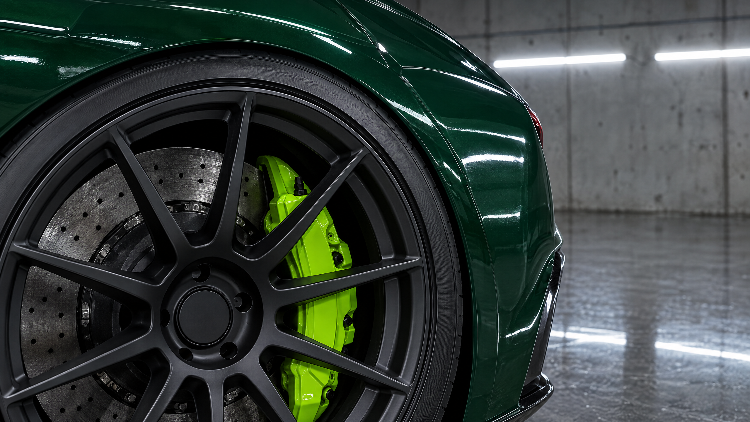 *  Precision millimeter-precise wheel fitment featuring matte black monoblock wheels and vivid colored brake calipers on a British Racing Green sports car in Houston, Texas.