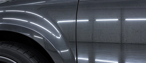Seamless auto body panel repair and perfectly restored factory body lines. Razor-straight studio light reflections on a repaired truck fender, proving unmatched structural and cosmetic auto body prep and finish work in Houston, TX.
