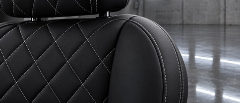Black Nappa leather interior with chalk white diamond stitching in Houston. Bespoke automotive upholstery styling featuring sharp contrast stitch patterns for luxury cars.