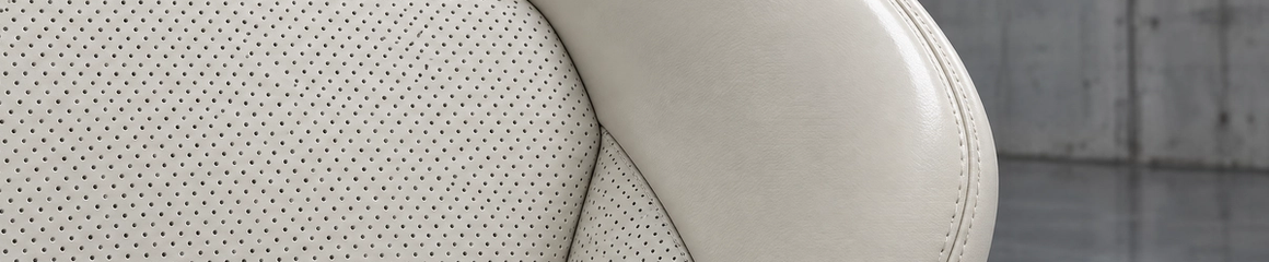 Custom ivory and off-white perforated leather car seats in Houston. High-end bucket seat upholstery, micro-perforations, and precision bolster wrapping for luxury vehicles.