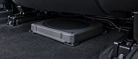 Stealth under-seat powered subwoofer and compact car audio installation in Houston. Hidden amplifier and subwoofer mounting for trucks, EVs, and sports cars seeking space-saving audio upgrades.
