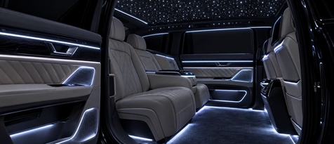 Fully synchronized custom automotive interior lighting system. Color-matched starlight headliner and ambient door LEDs in a luxury EV, showcasing premium cabin transformations at our Houston design studio.