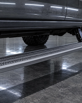 Motorized power running boards and retractable drop steps for lifted trucks in Houston. Electric side step installation for seamless cab access and high ground clearance.