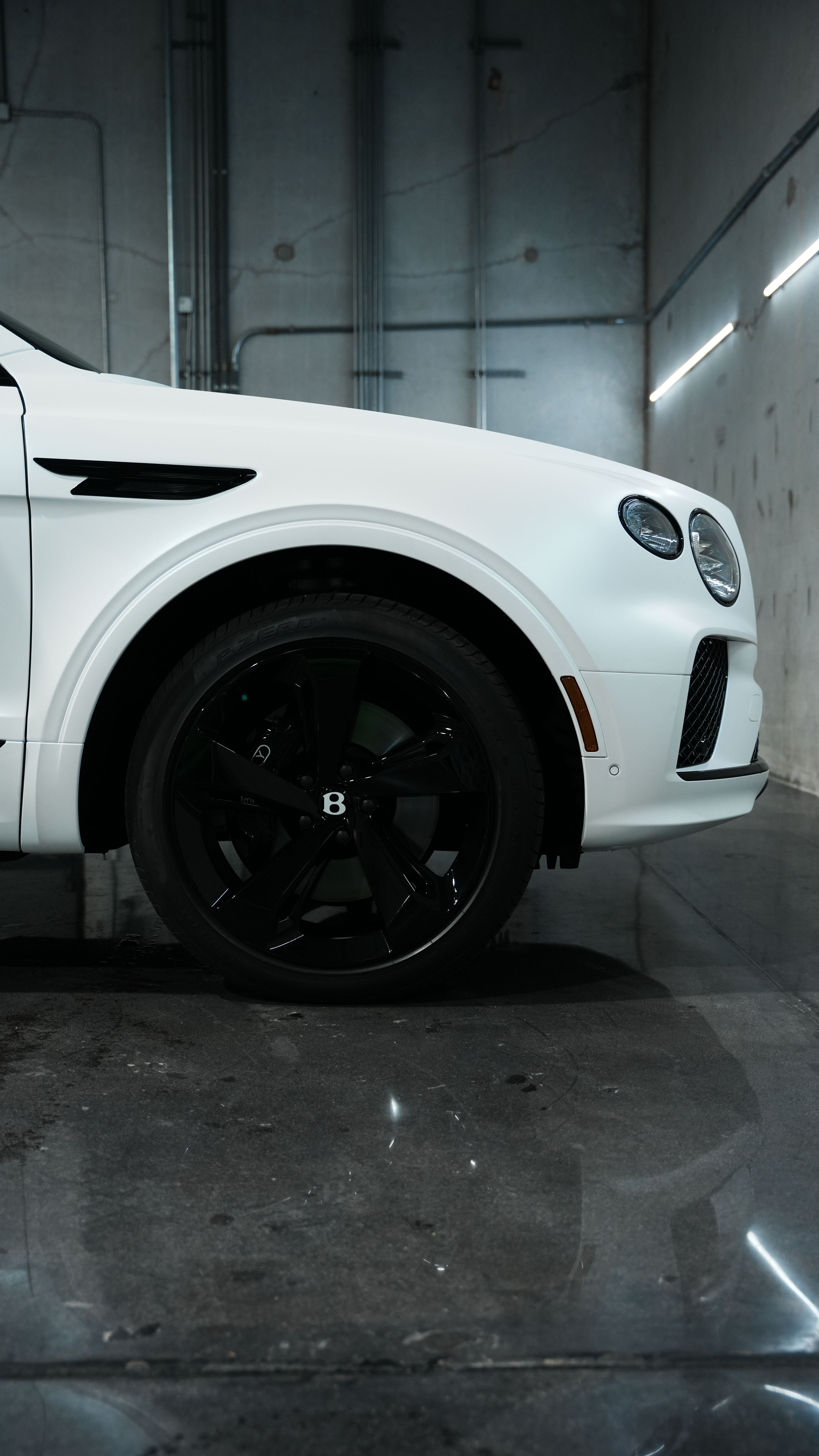 wheel blackout package for fully blacked out vehicle bentley betayanga. Custom wheel powder coating and brake caliper painting in Houston, near Katy and The Woodlands. Satin black wheel packages and stealth exterior detailing for custom car builds.