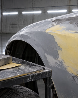 Expert auto bodywork, dent repair, and panel smoothing for custom automotive builds. Precision block sanding and surface prep on a classic vehicle fender in our Houston, TX shop, ensuring a completely wavy-free foundation before custom paint application.