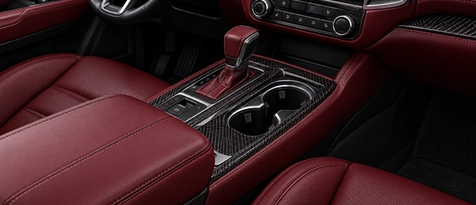 Deep garnet red leather interior and custom console wrapping in Houston, TX. Exotic red cabin styling and seamless trim integration for sports cars and luxury SUVs.