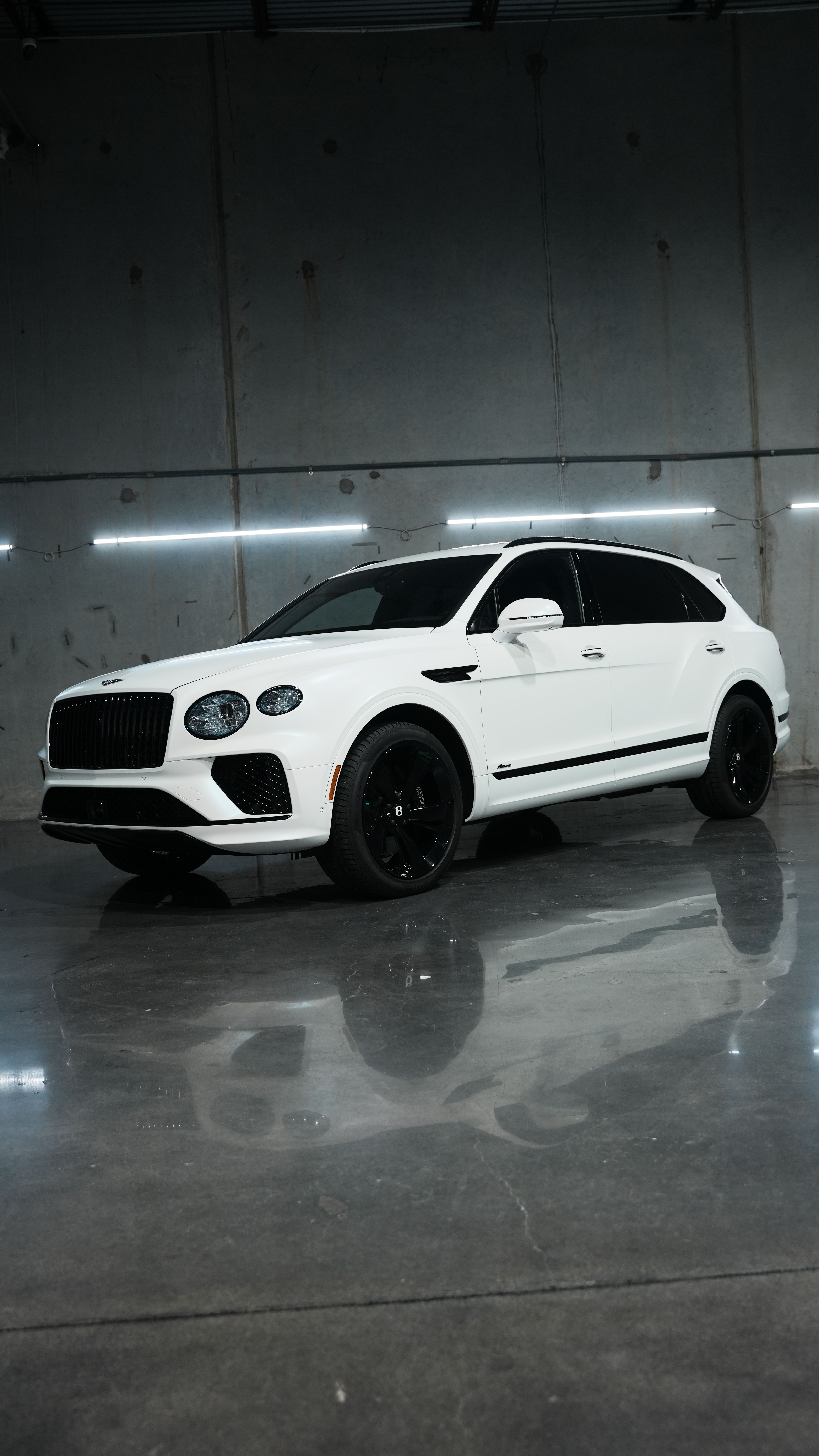 Fully blacked out Bentley vehicle consisting of a blackout package done in house. Complete vehicle blackout packages and full chrome deletes in Houston, TX. Professional gloss black trim conversions, badge blackouts, and window surround wrapping for high-end vehicles.