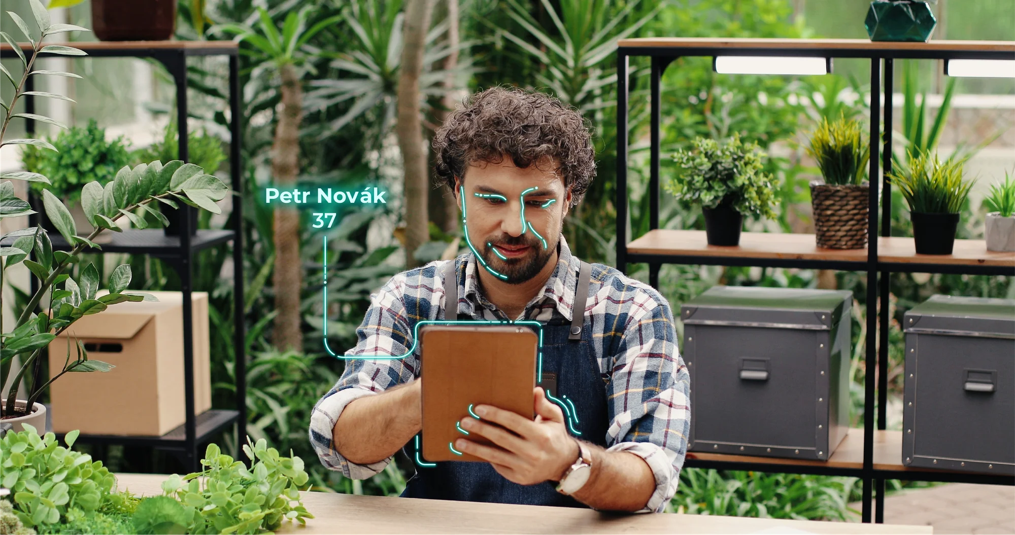 A person verifies their identity with a selfie on a tablet, with a face-matching overlay