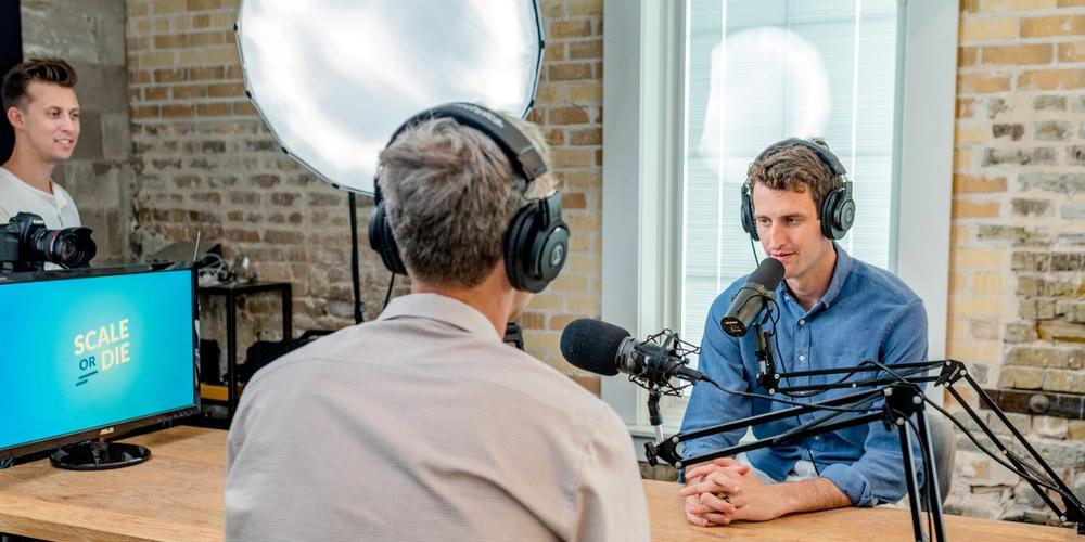 2 men filming a podcast show