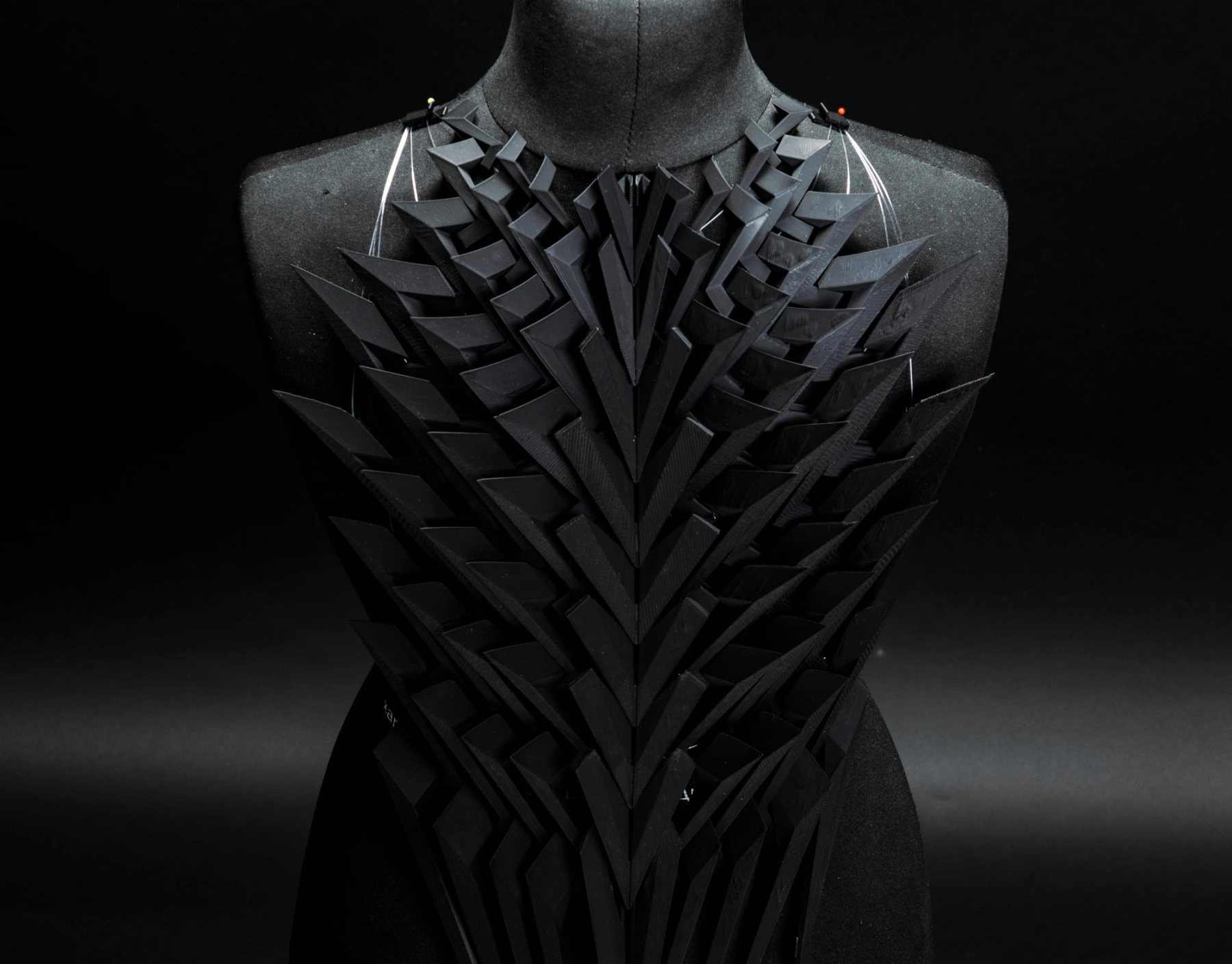 Occultatum Periculum — 3D-printed modular back armour, backlit against black