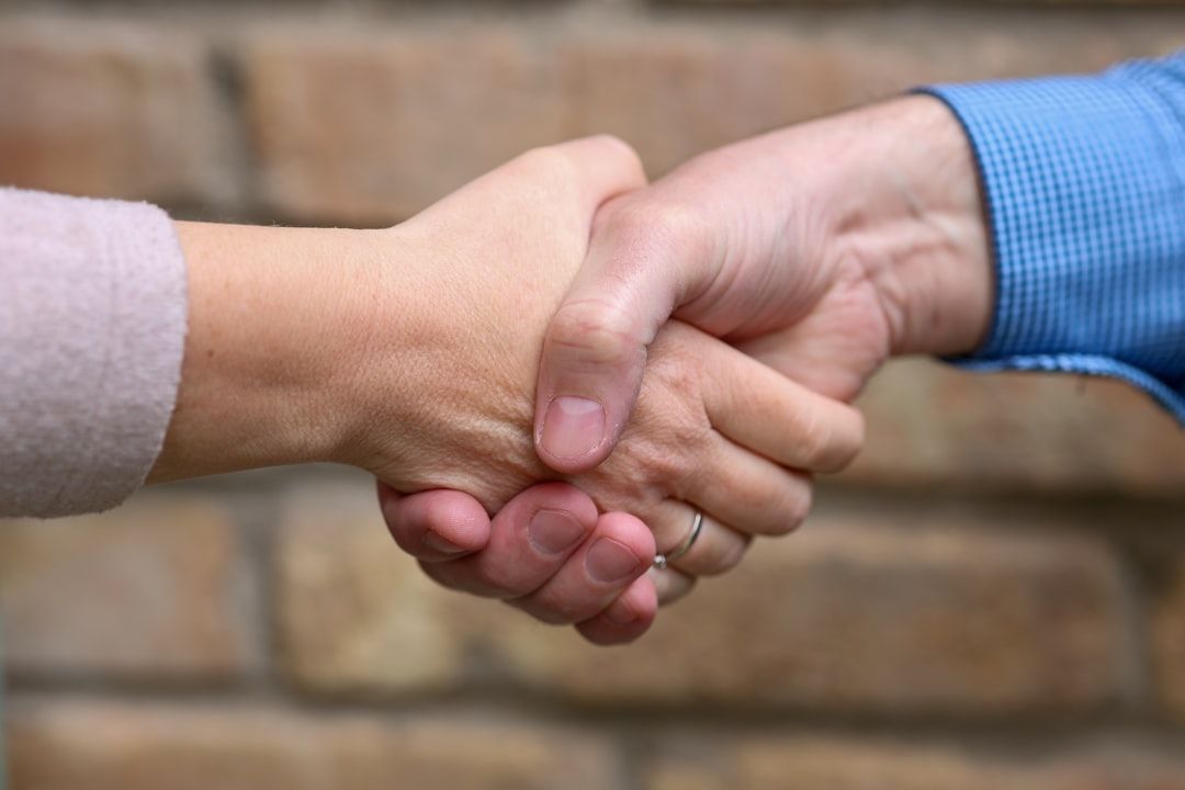 of a homeowner shaking hands with a contractor - Vancouver general contractor