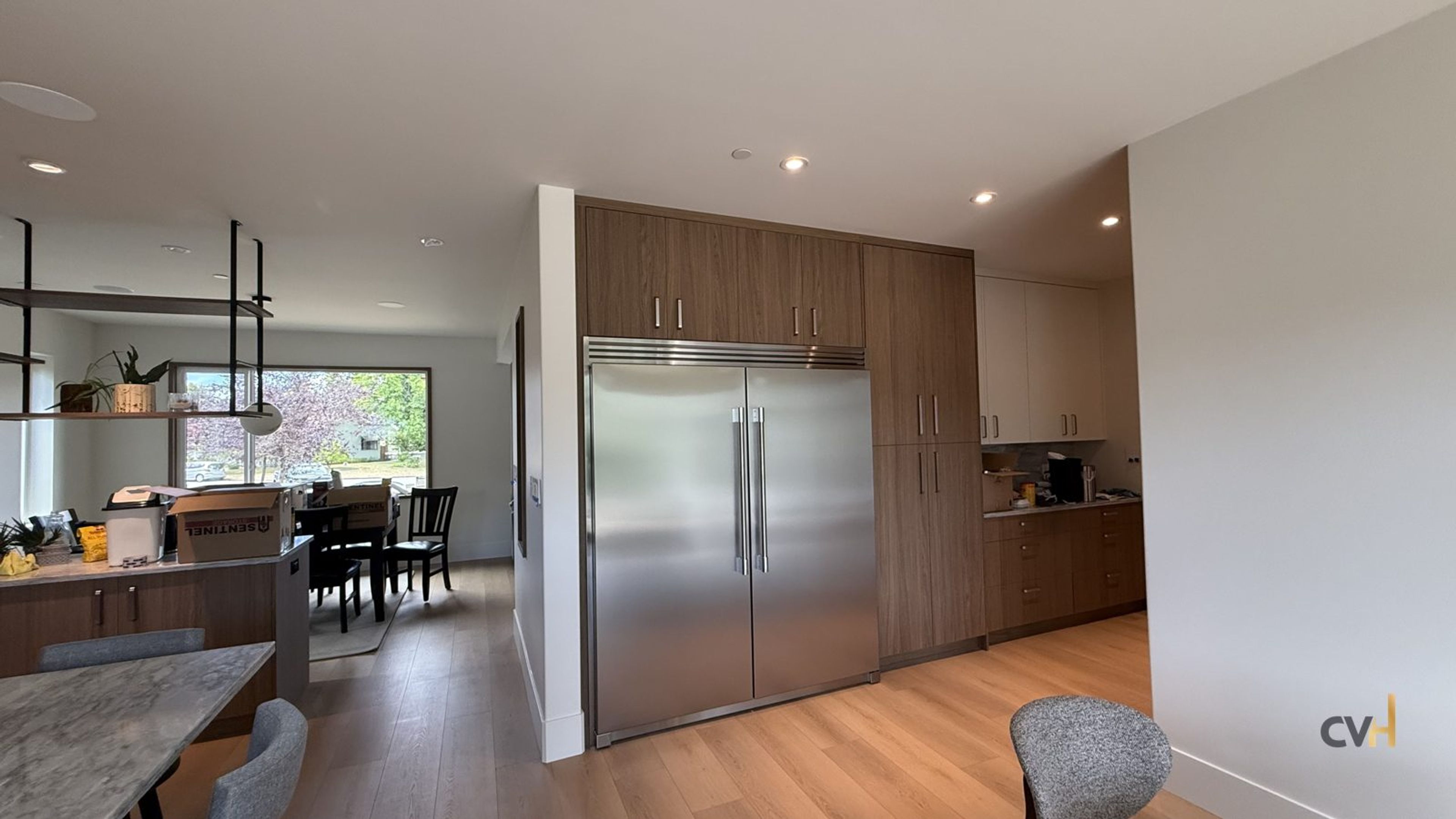 Kitchen renovation in East Vancouver by CoreVal Homes: stone island edge, integrated refrigerator columns and fitted pantry wall