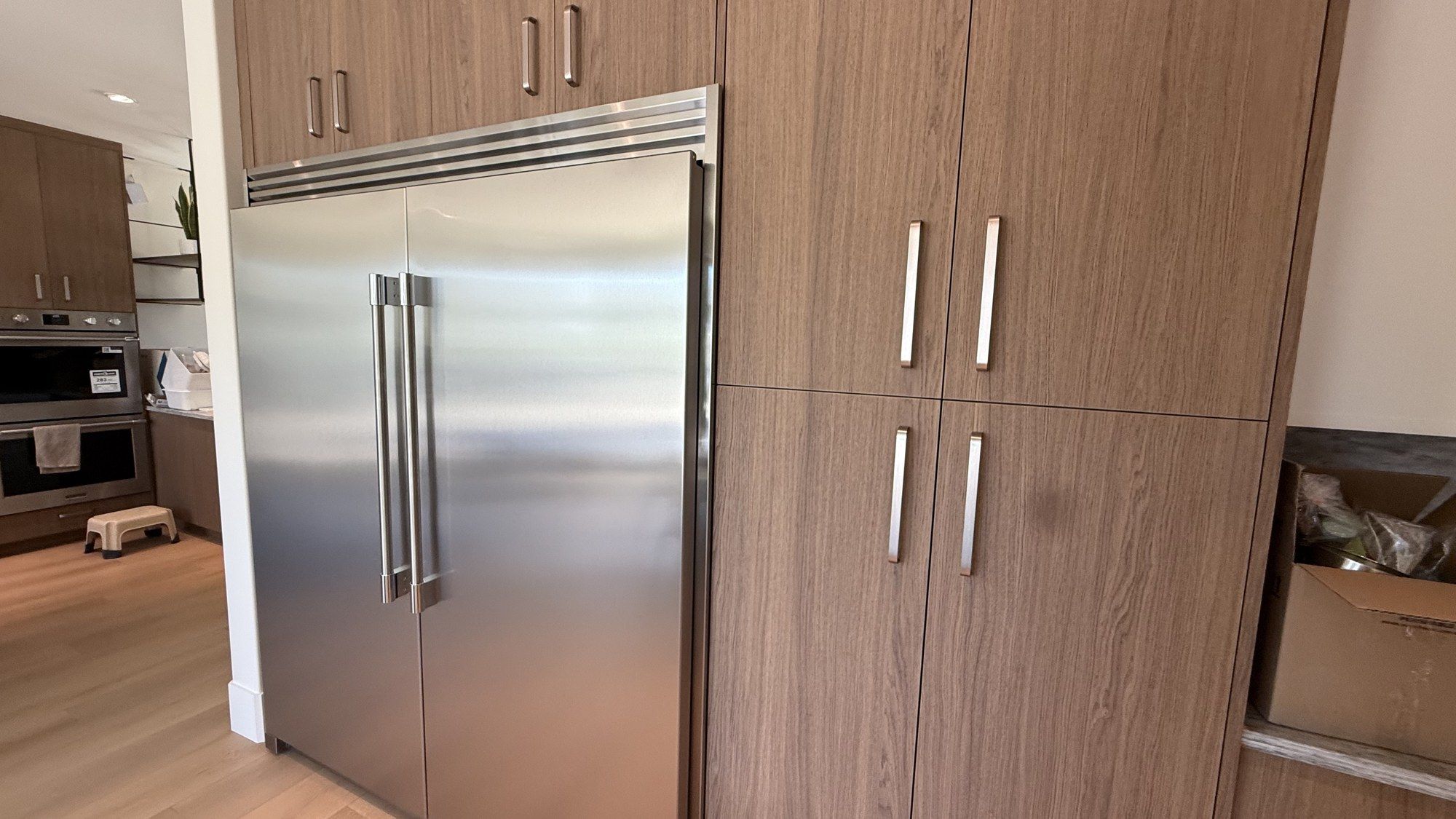 Full-height kitchen cabinetry and integrated appliances after renovation