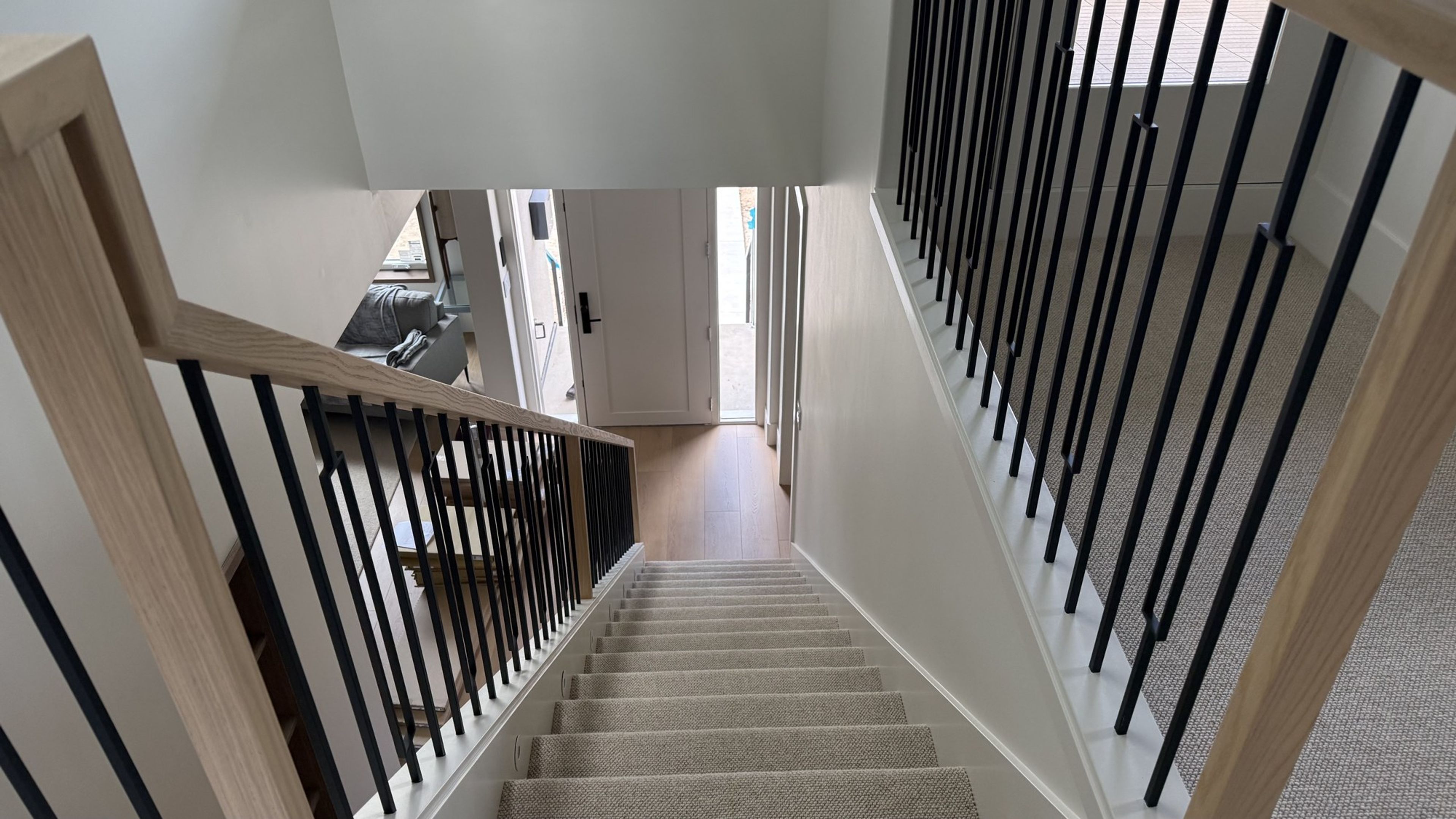 Reconfigured staircase with black spindles serving the new third floor