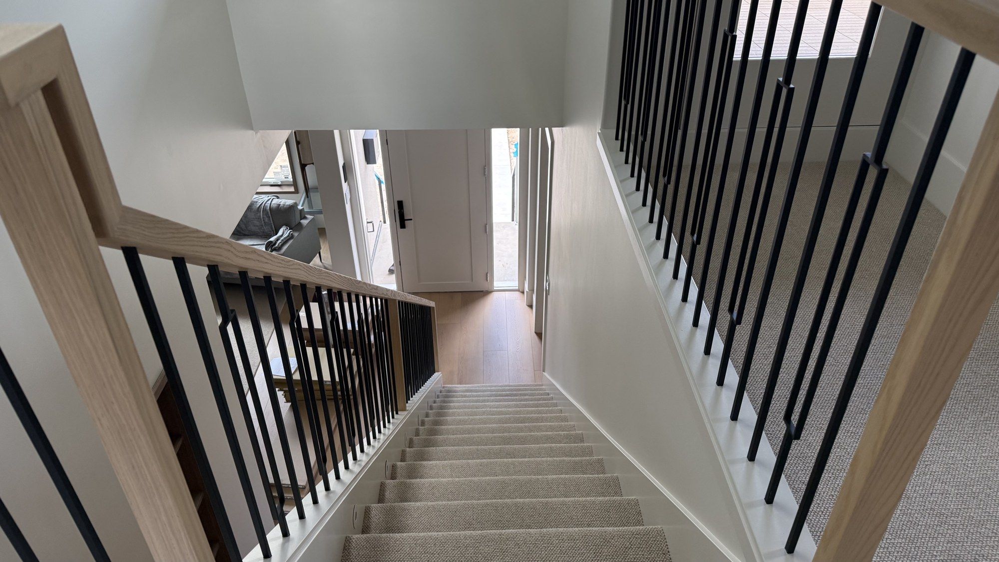 Reconfigured staircase with black spindles serving the new third floor