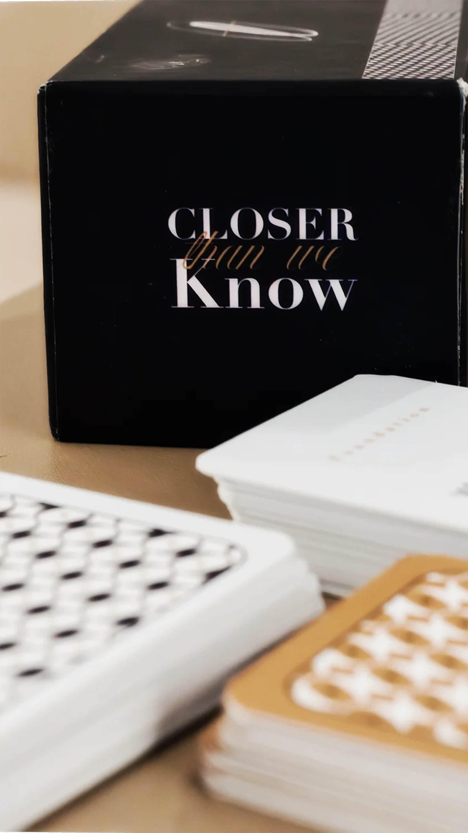 Closer Than We Know black product box beside stacks of printed conversation cards