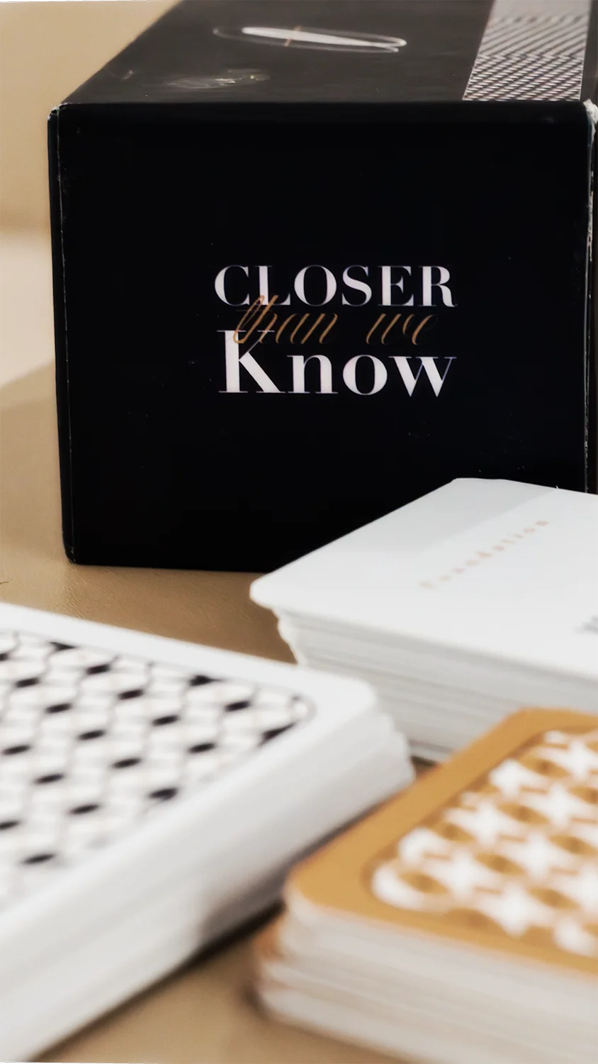 Closer Than We Know black product box beside stacks of printed conversation cards