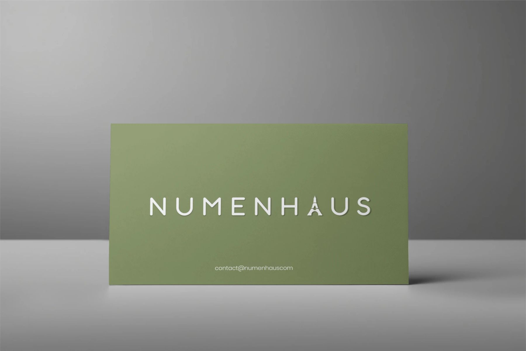 Numenhaus green wordmark on a simple card mockup