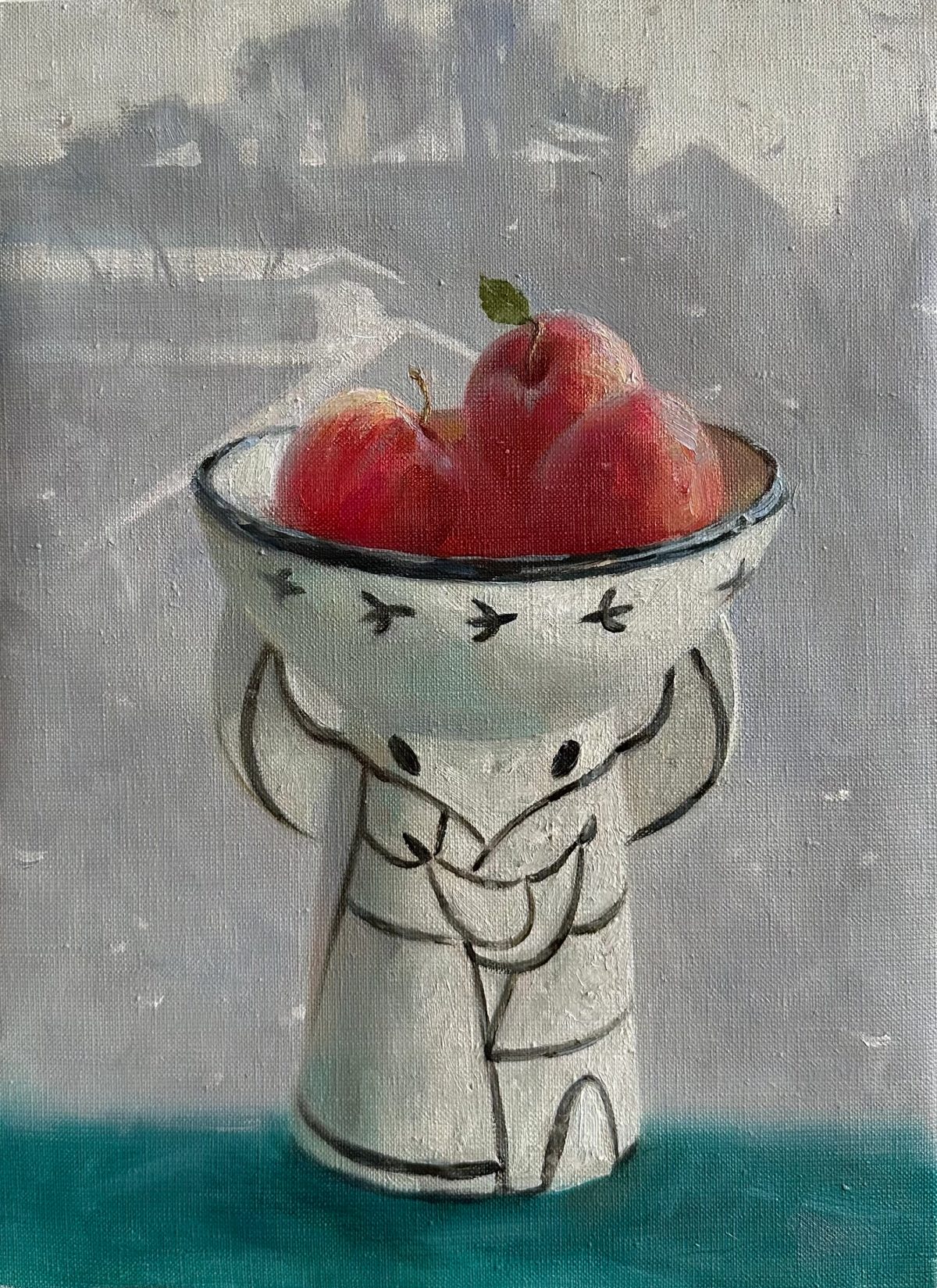 Red apples in a painted bowl beside a window.