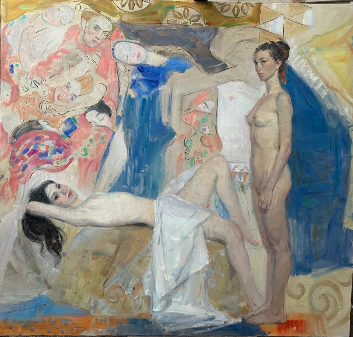 Nude women posed in a studio, surrounded by large painted figures and patterned walls.