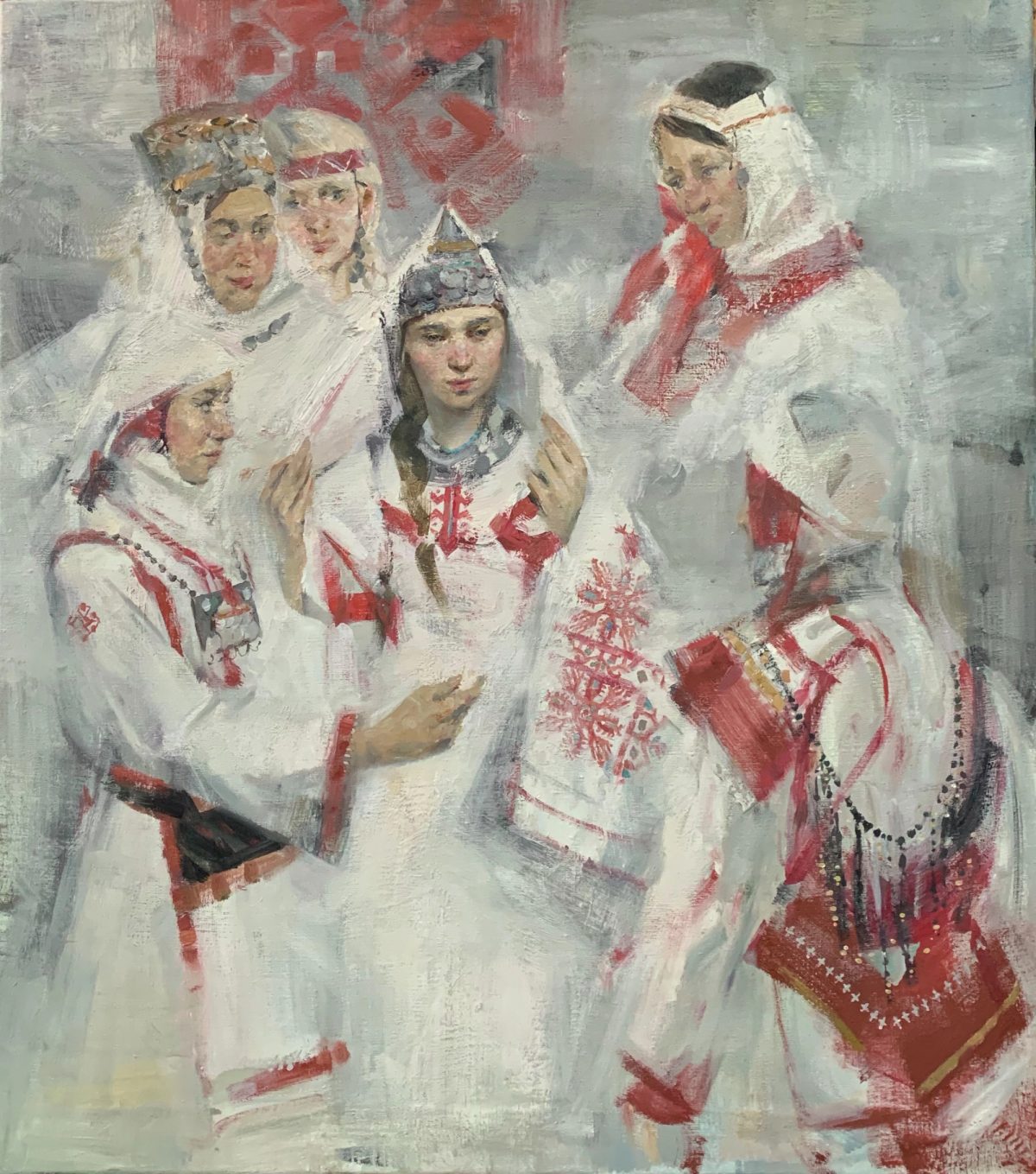 Four women and a child in white traditional dress with red embroidered details.