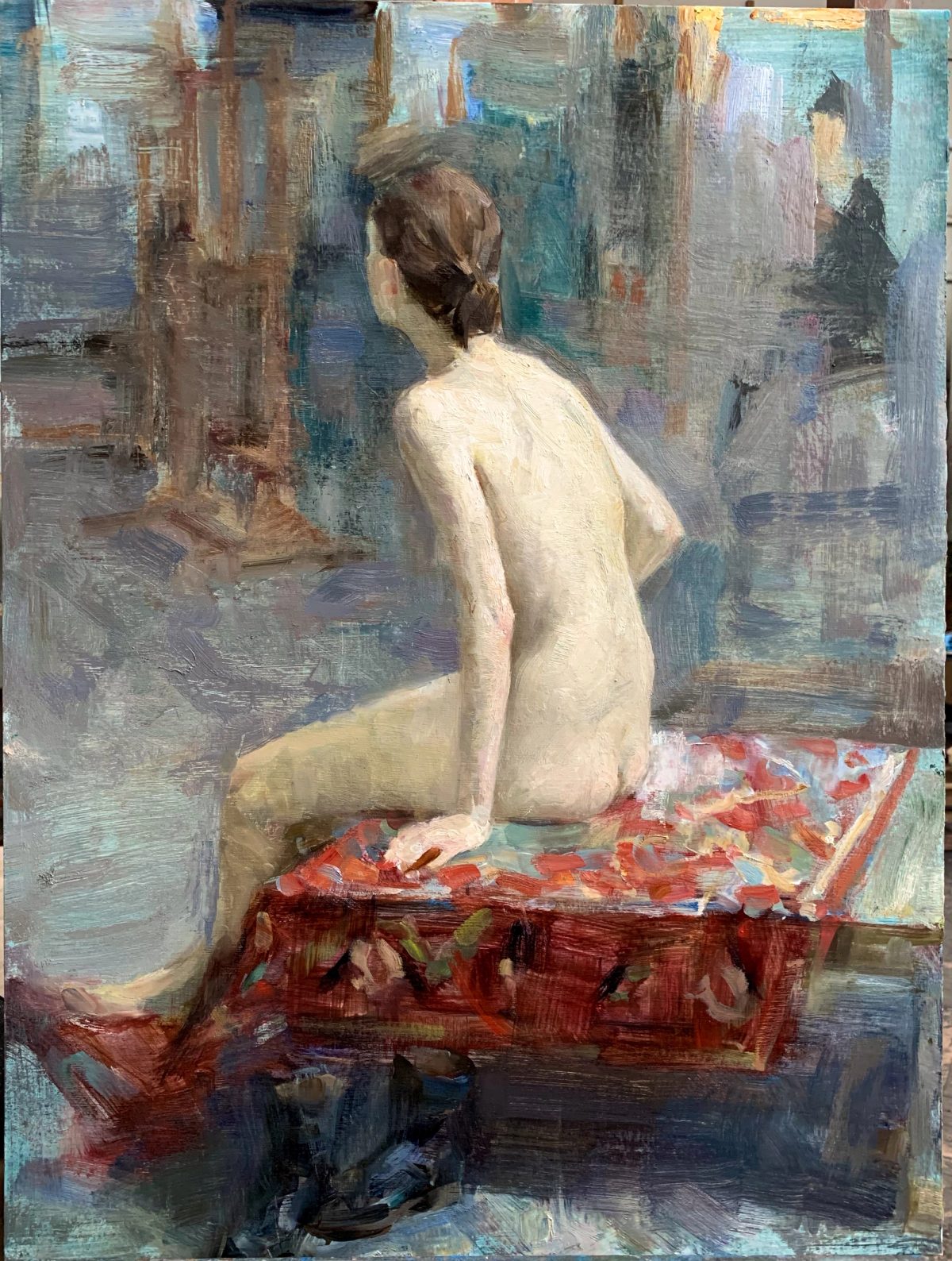 Nude woman seated on a red patterned platform in a studio interior.