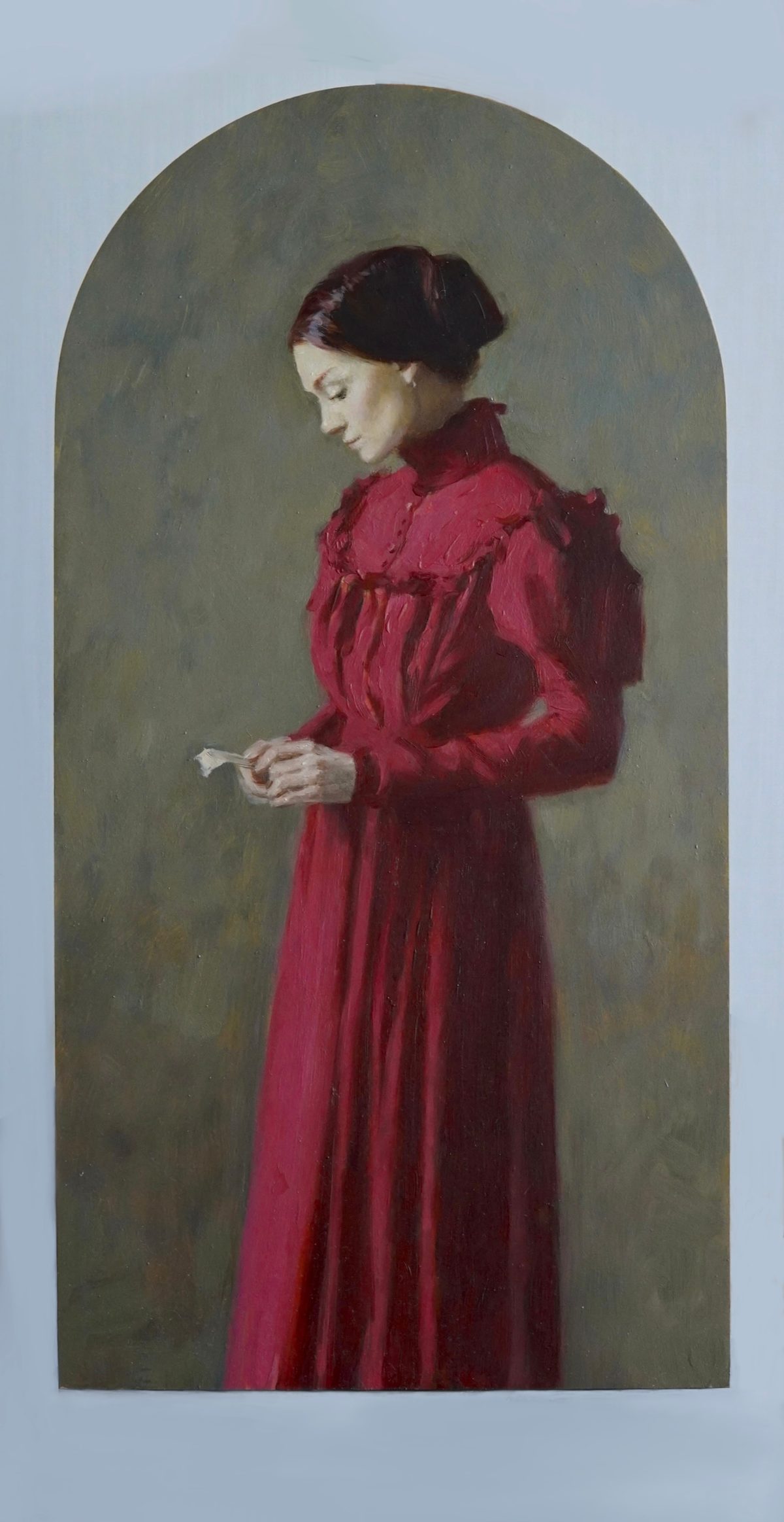 Woman in a red dress holding a letter against an arched green background.