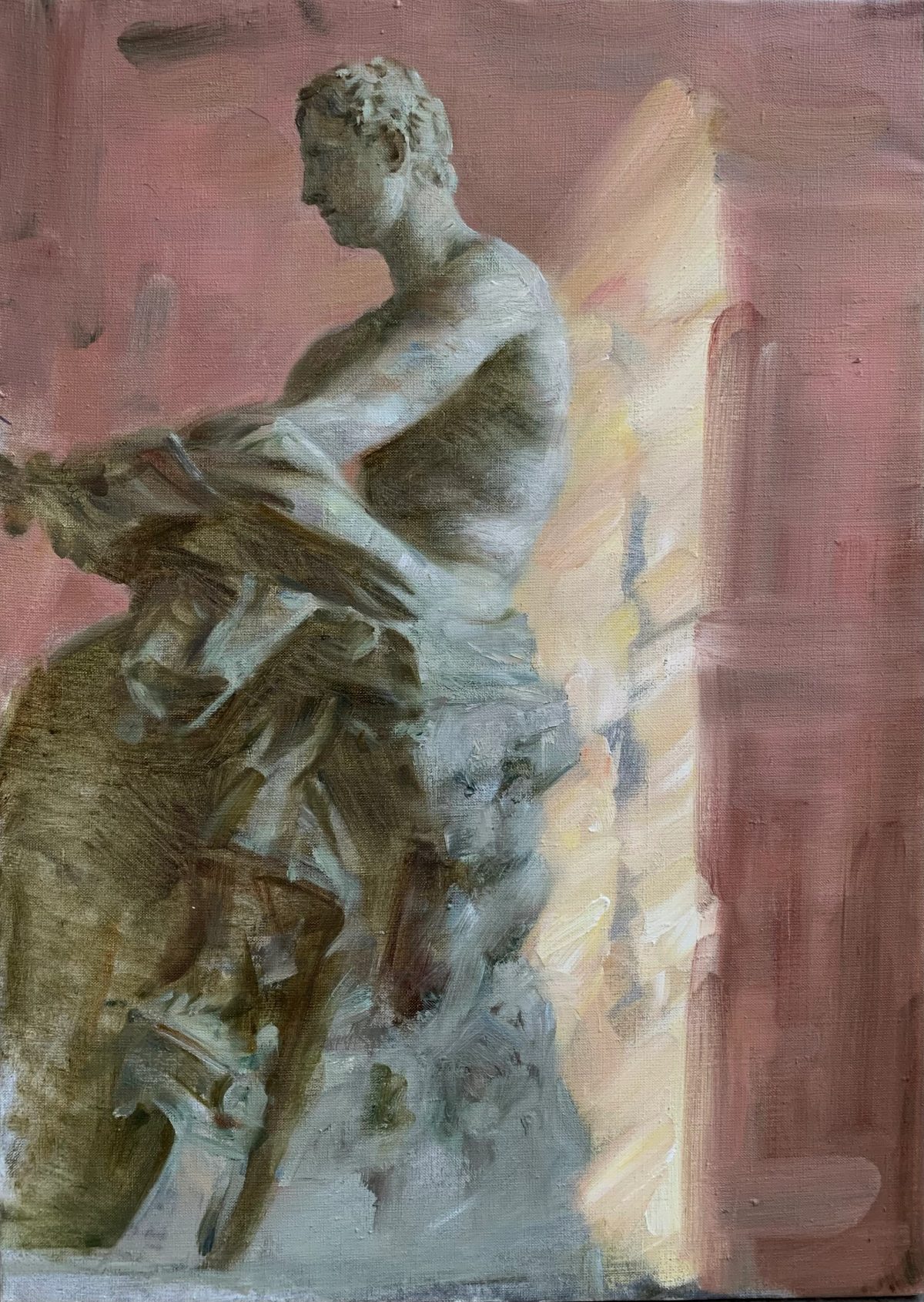 Plaster sculpture of a seated male figure in profile against a pink wall.