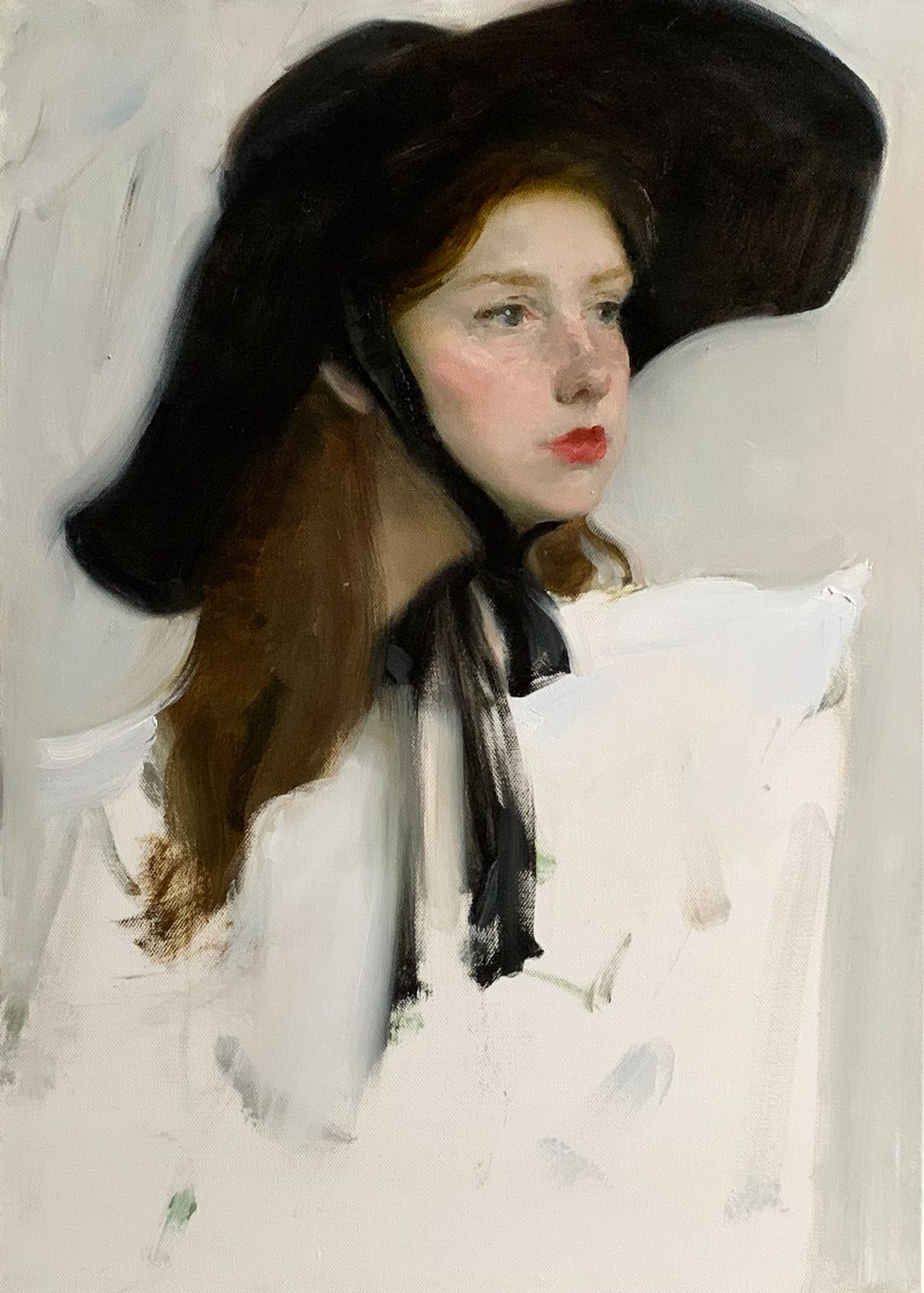 Portrait of a woman in a wide black hat and white blouse with a black bow.