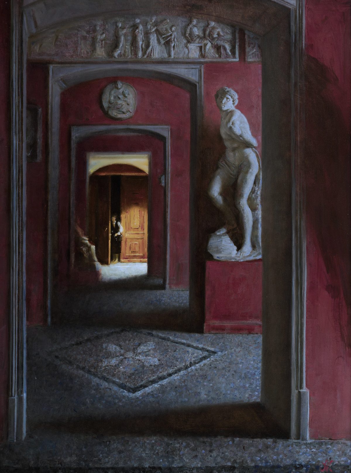 Red gallery interior with classical sculptures and an open doorway.