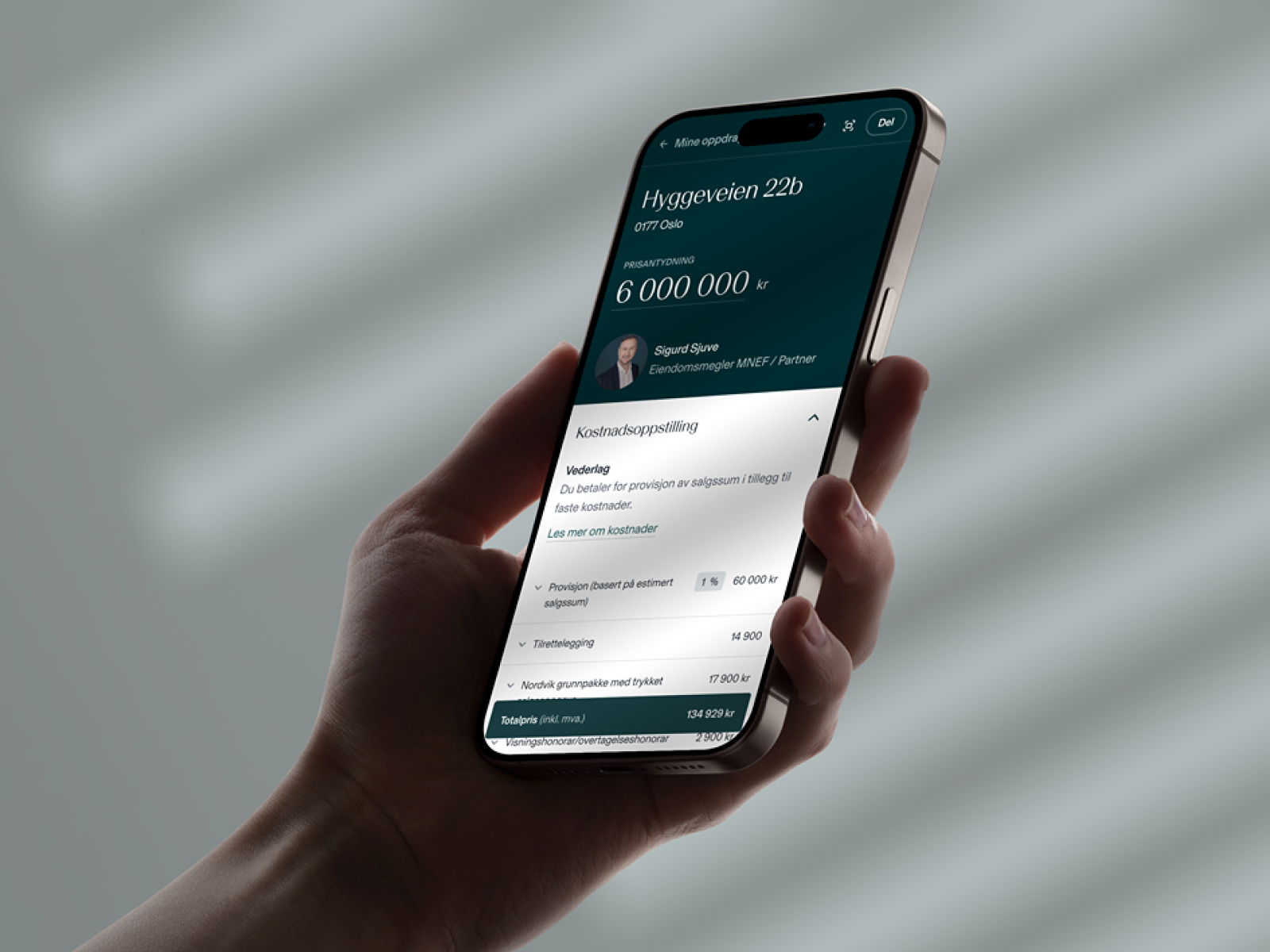 a hand is holding a phone with a screen that says hyggeveien 22b