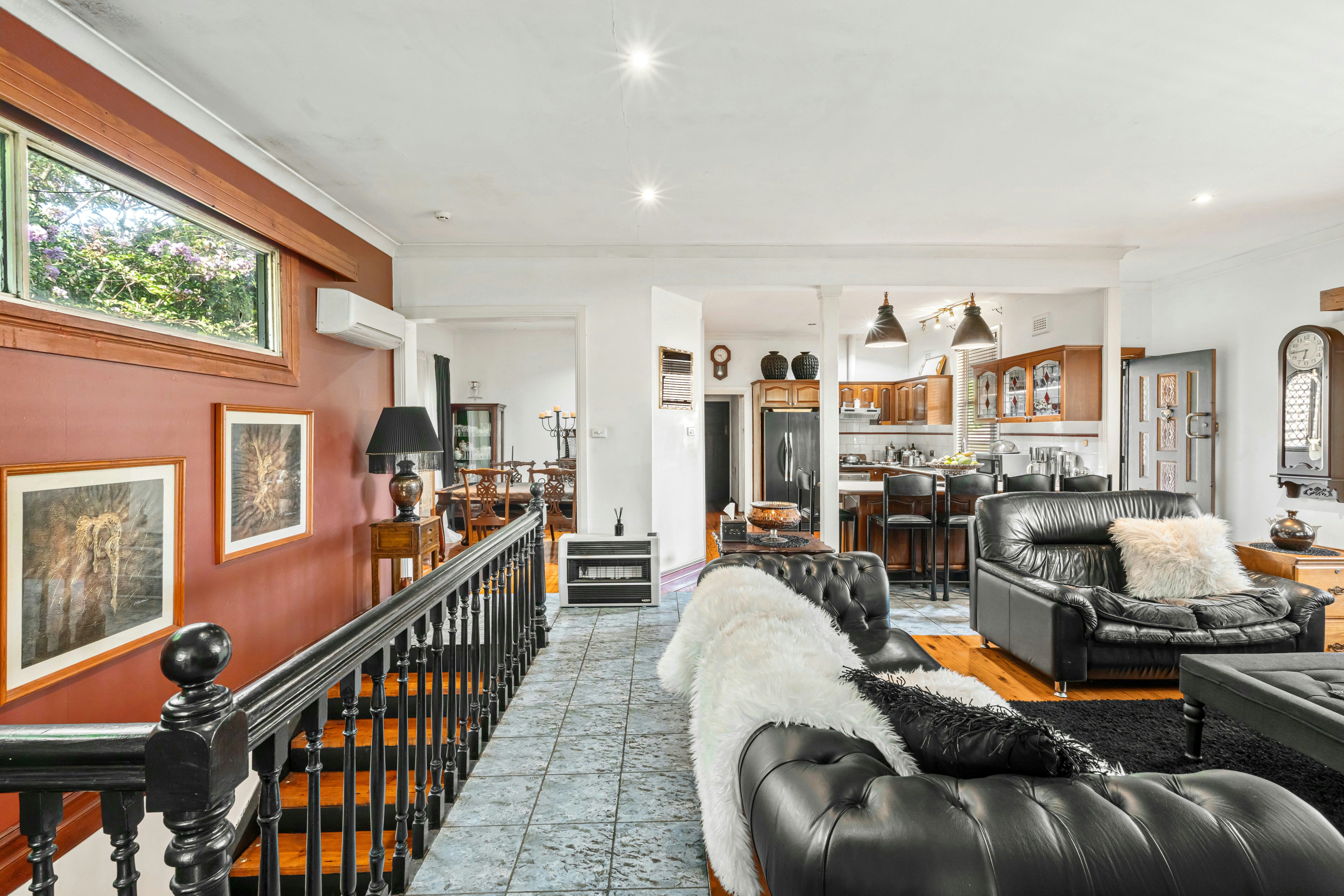A living room filled with furniture and a staircase
