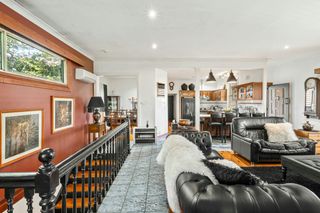 A living room filled with furniture and a staircase