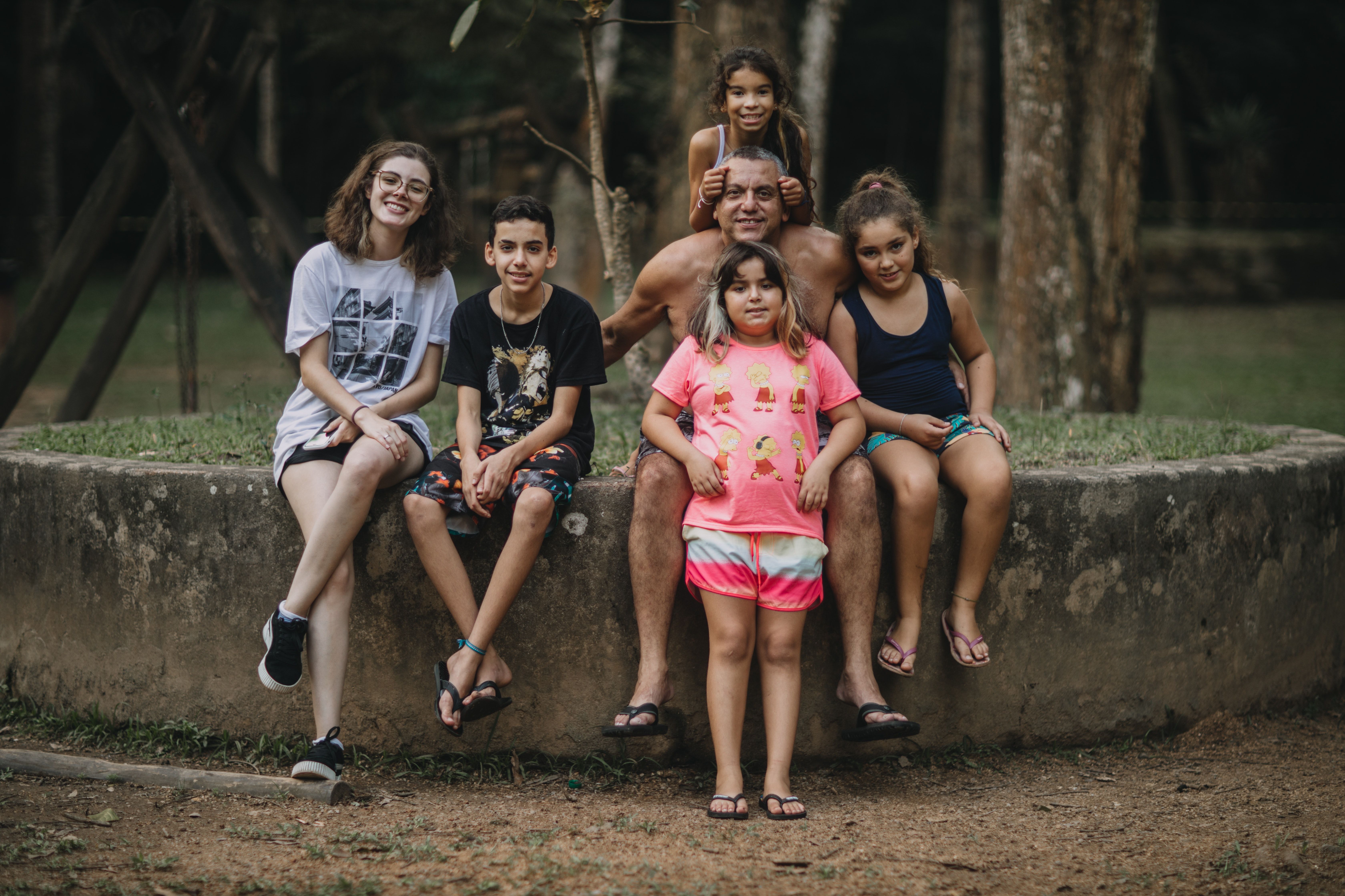 Picture of a family outside sitting on a fountain