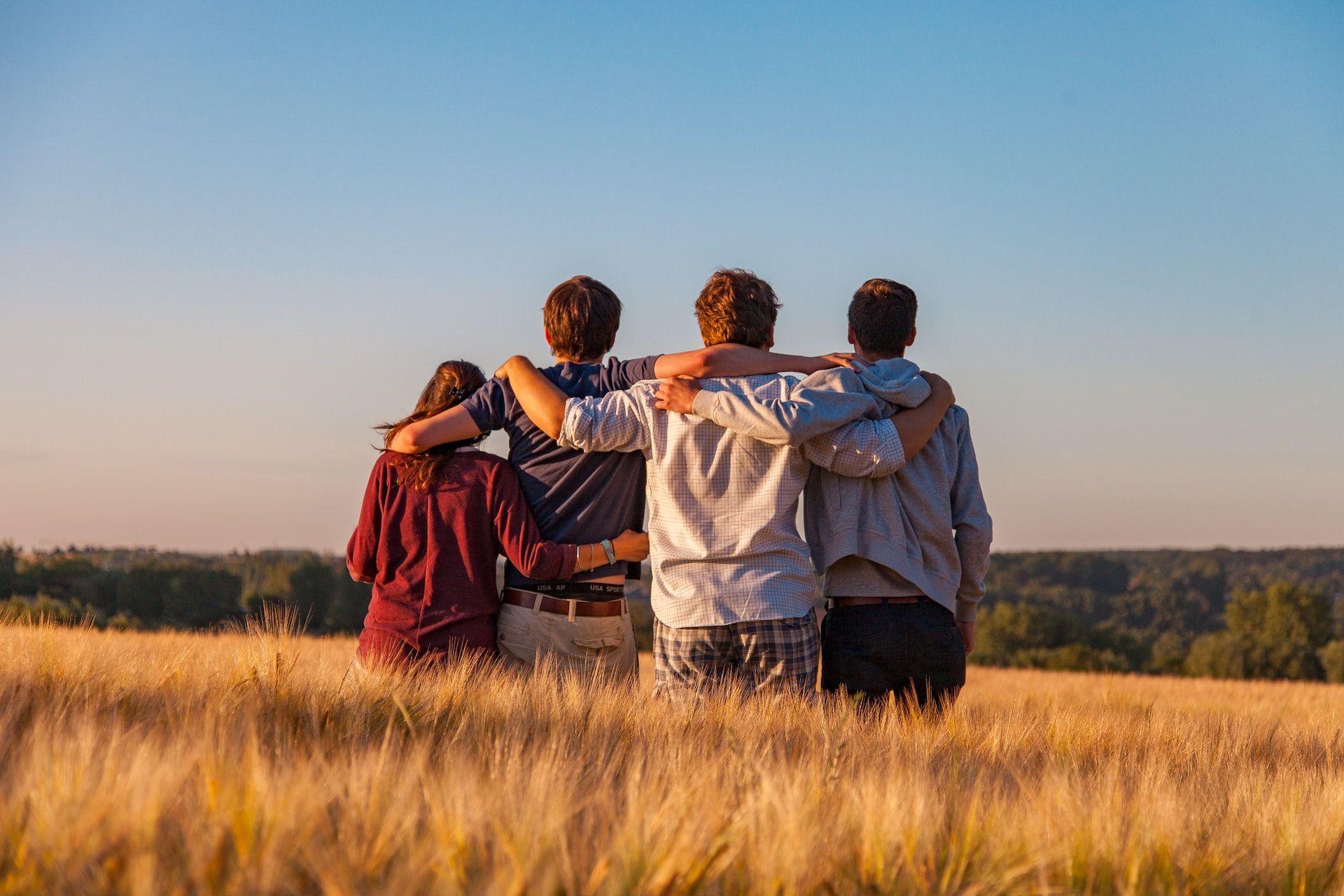 A family standing together in a wheat field