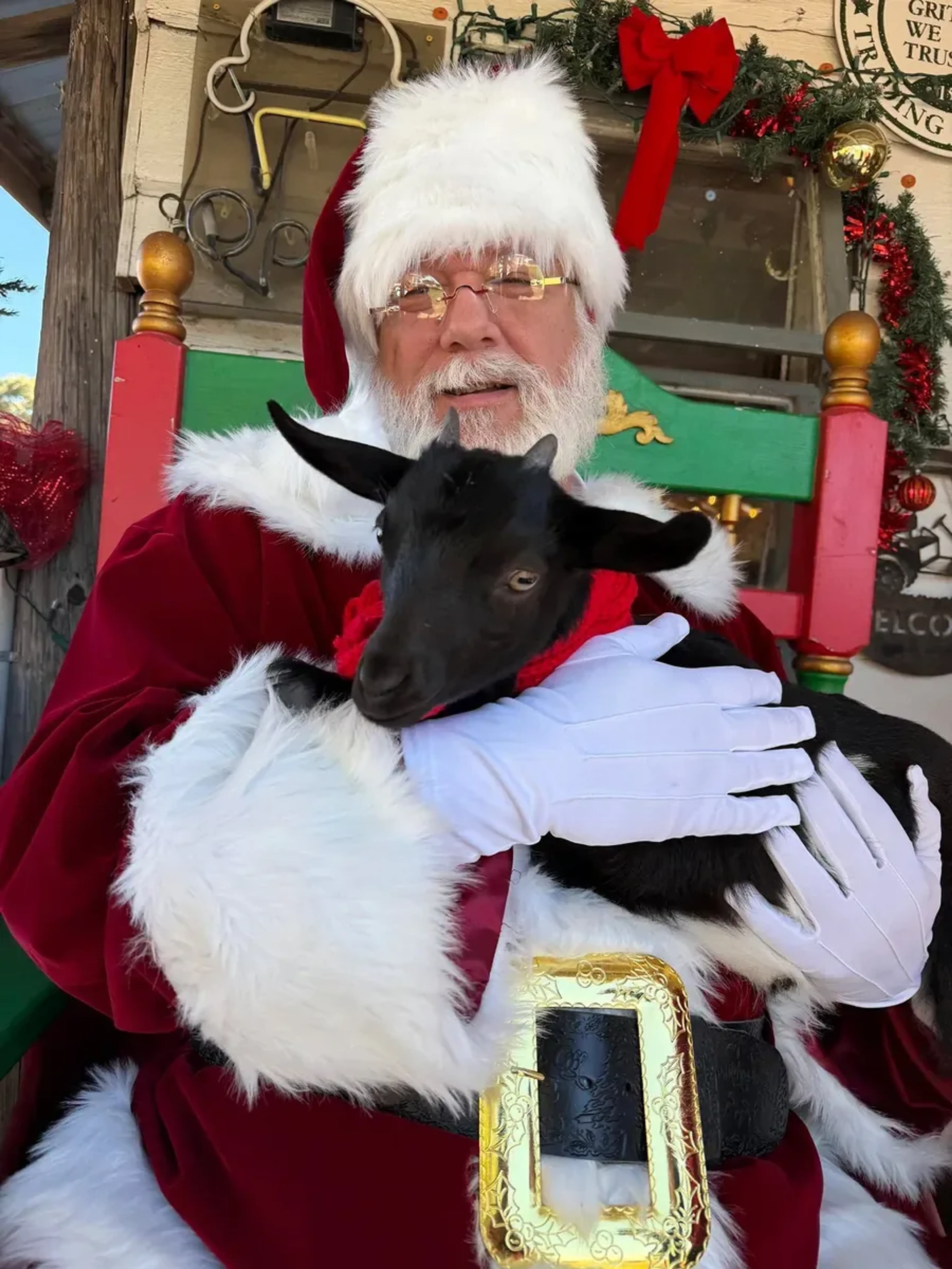Santa holding a black goat at the Cowboy Christmas Market Day