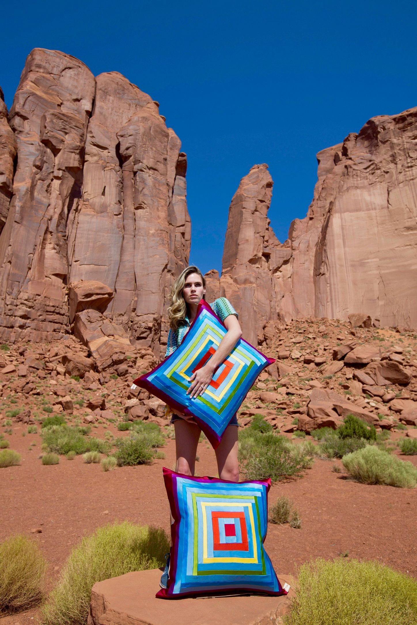 Image of cushions and artist Lillian Grant with mountainous backdrop